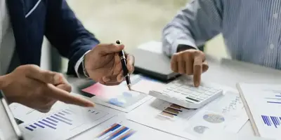 Startup founders discussing financial reports in a Nairobi office – Zidika Consulting