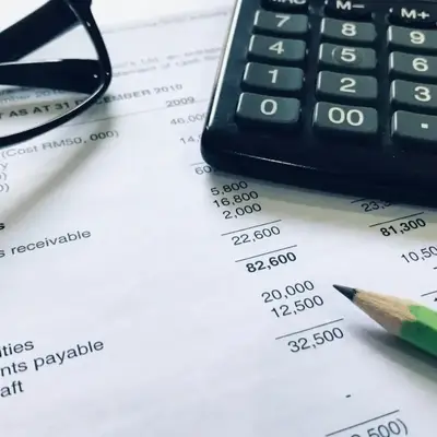 Accounting setup with report, calculator, and glasses – Nairobi – Zidika Consulting
