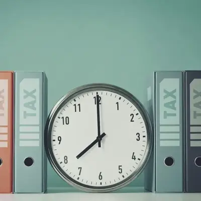 Clock between box files labeled TAX to highlight deadlines – Zidika Consulting Kenya