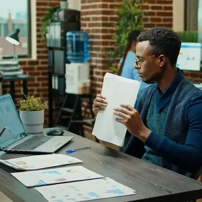 Man reviewing business records on a laptop for bookkeeping in Kenya – Zidika Consulting