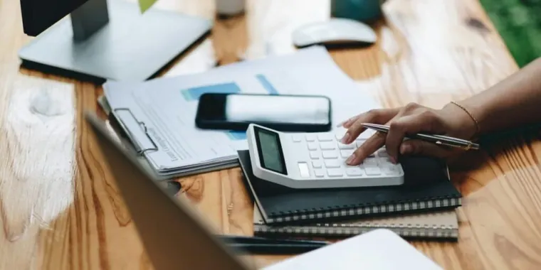 Bookkeeper recording transactions in a Kenyan business office