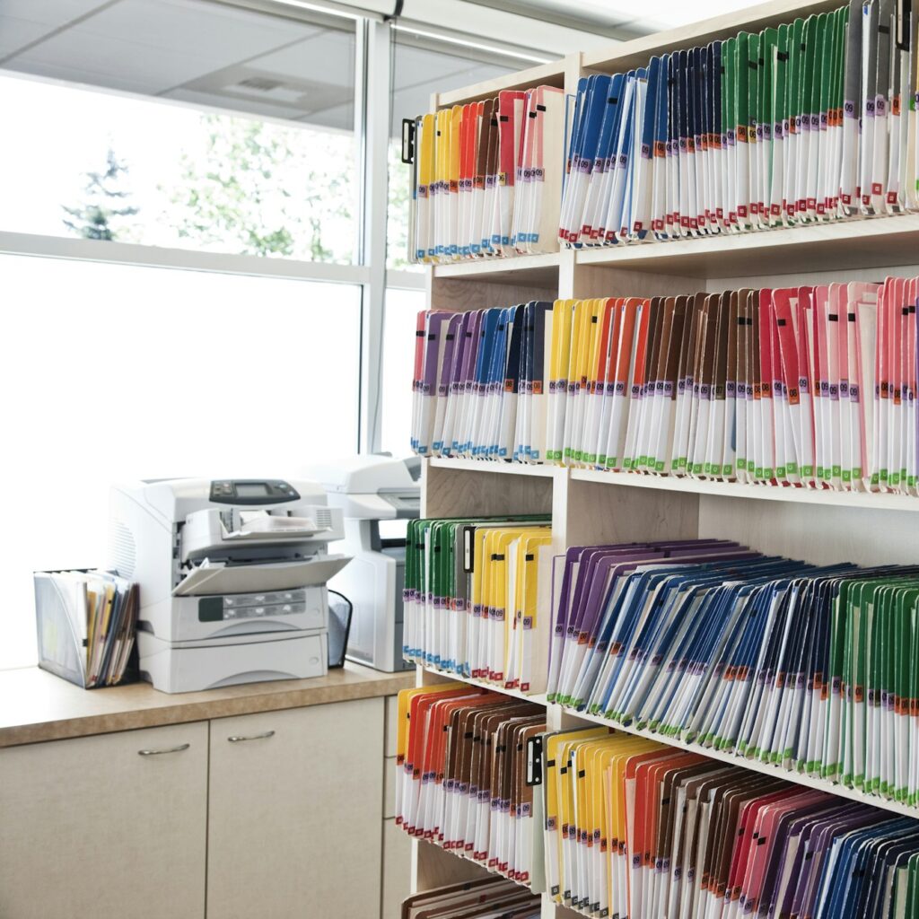 A group of colorful file folders in a dental office.