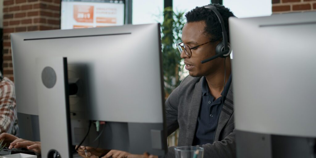 African american employee using headset at customer service
