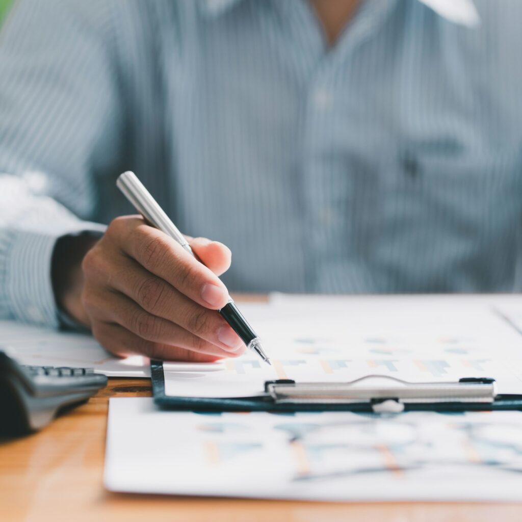 Financial businessman calculating corporate income tax data And analyzing charts of financial stocks