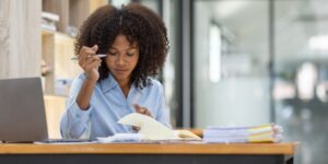 Successful african american accountant business woman work document tax on laptop computer in office