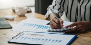 Woman in a Nairobi office recording accounting entries for her business – Zidika Consulting, Kenya