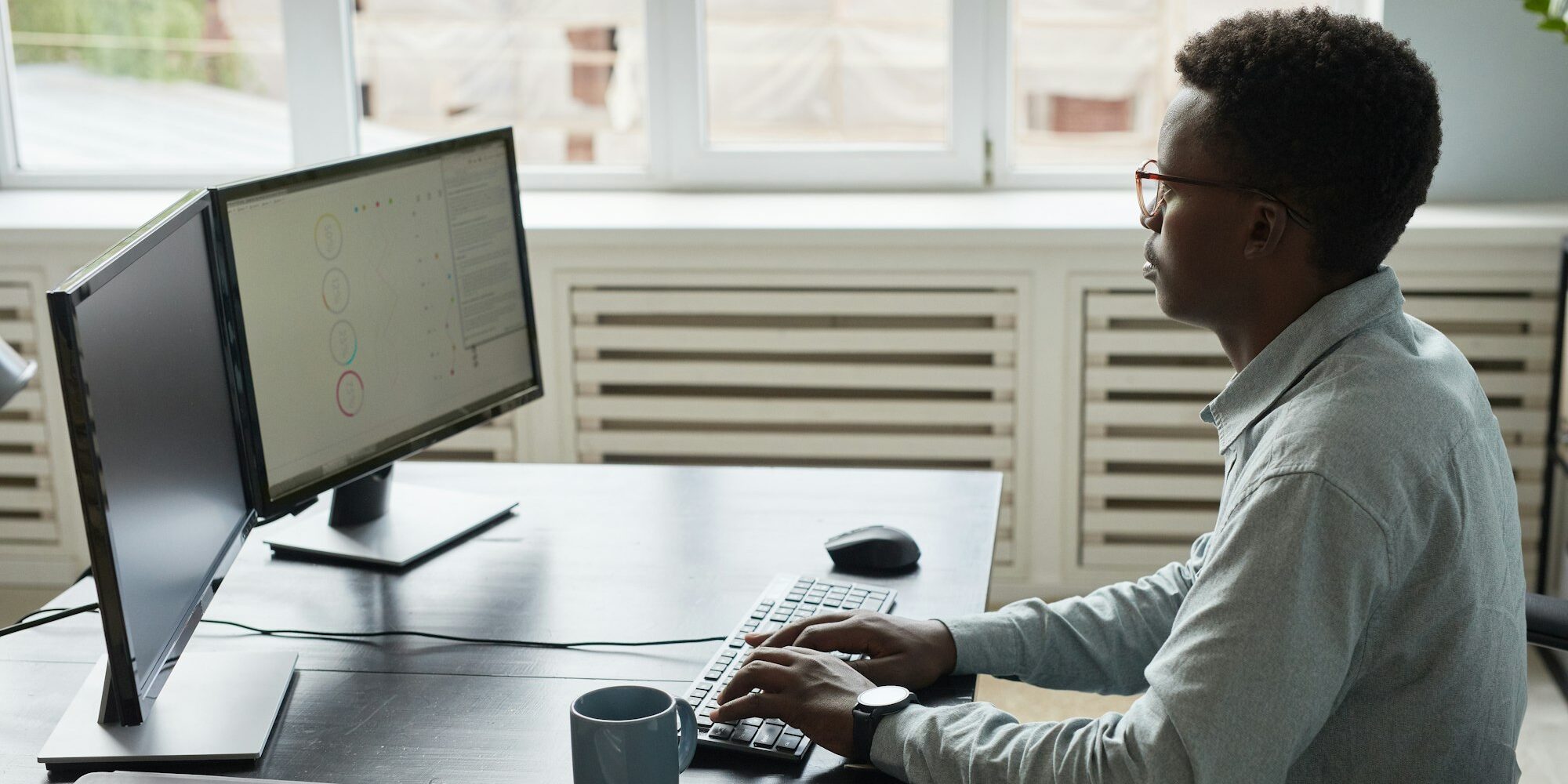 Freelancer in Nairobi using dual screens to file taxes – Zidika Consulting, Kenya