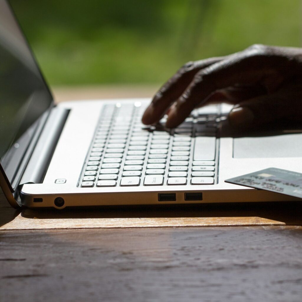 Human hand using a laptop for financial analysis – Zidika Consulting, Nairobi