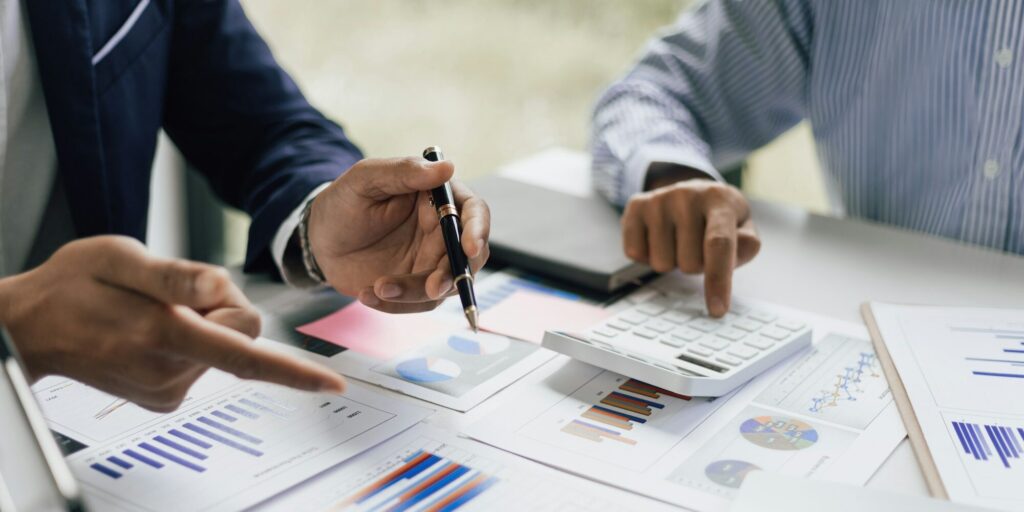 Startup founders discussing financial reports in a Nairobi office – Zidika Consulting