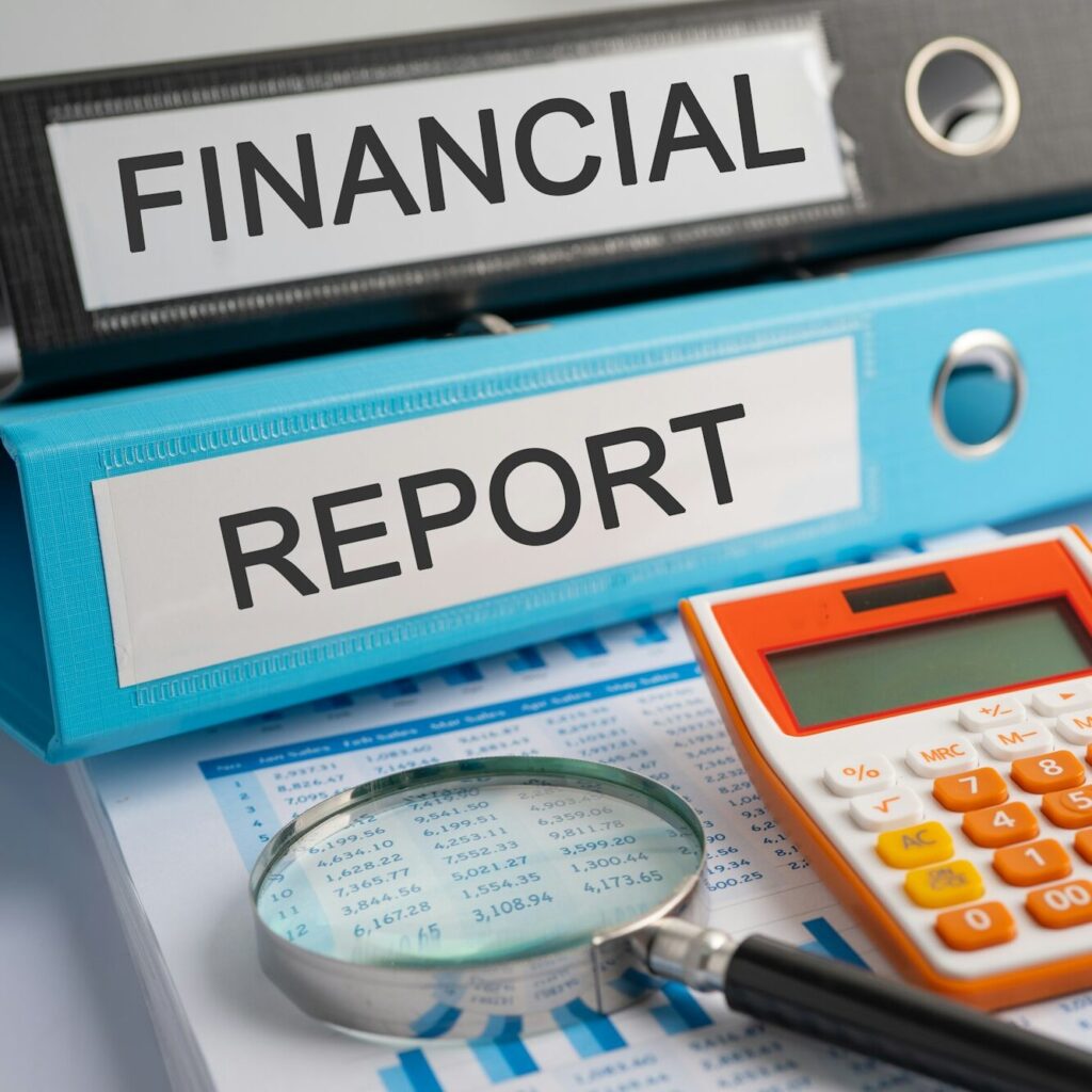 Financial report files with a calculator and magnifying glass in Nairobi – Zidika Consulting, Kenya