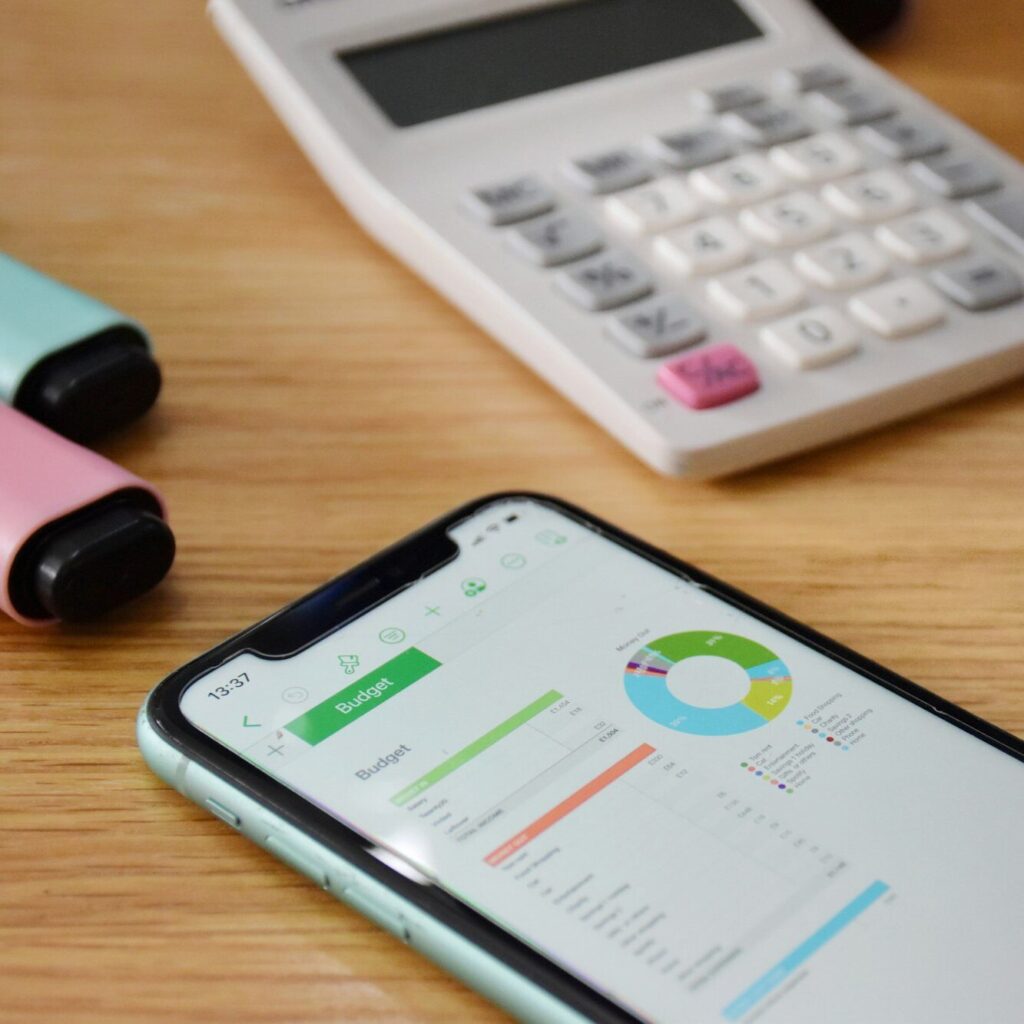 Smartphone displaying pie chart with calculator and markers – accounting insights by Zidika