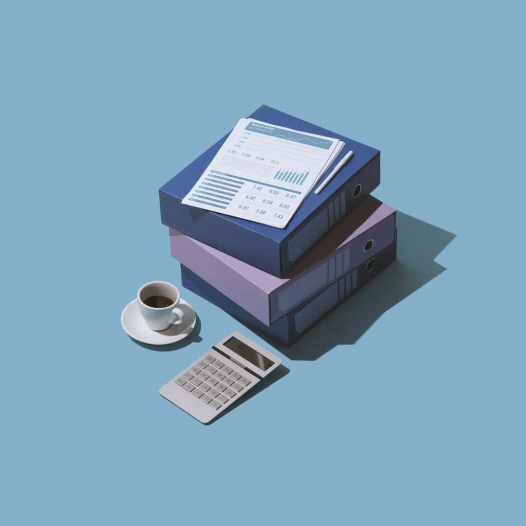 Three box files, coffee, and calculator for budget filing – Zidika Consulting, Kenya