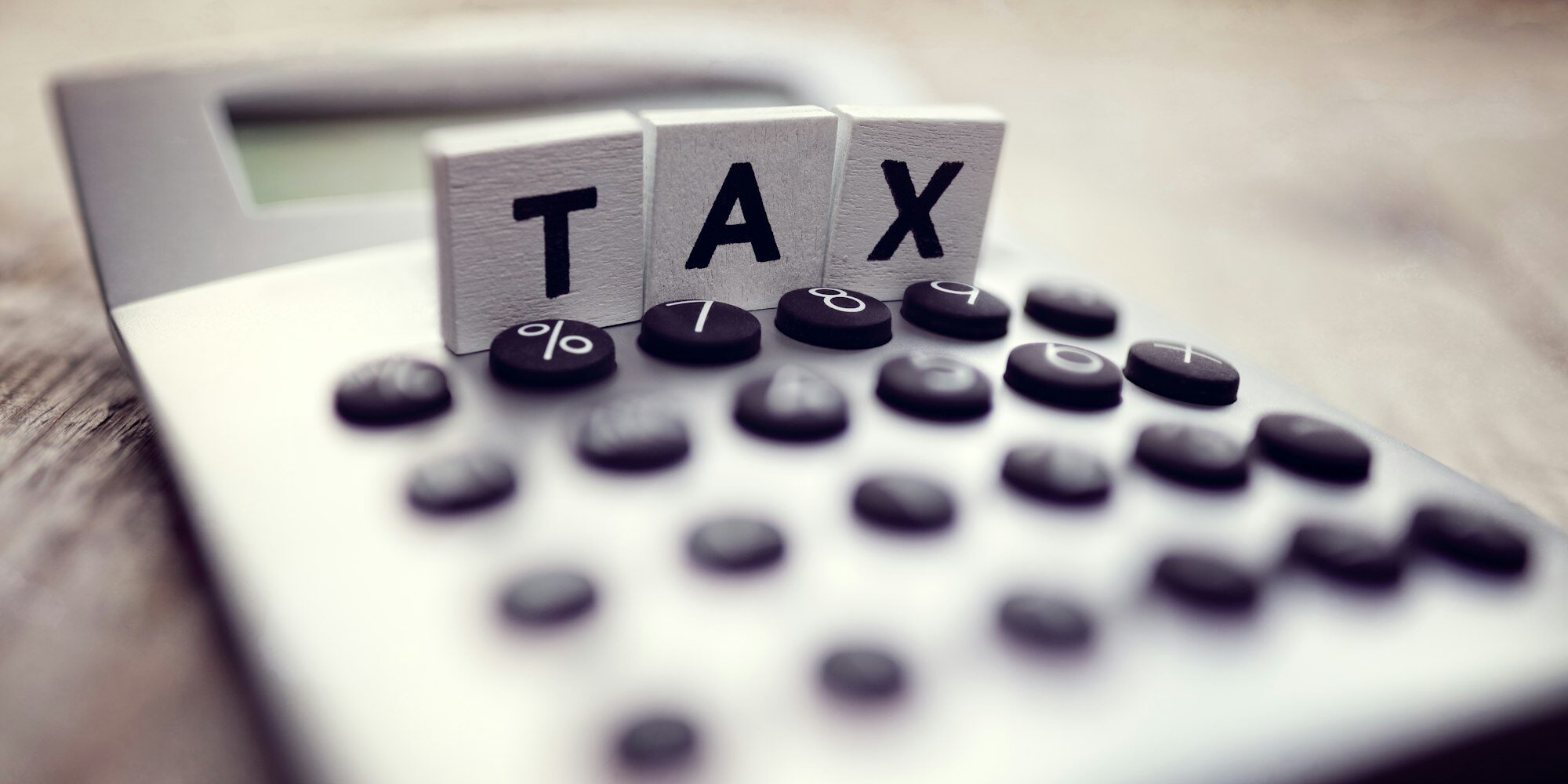 Wooden TAX blocks on top of a calculator for deduction planning – Zidika Consulting, Kenya