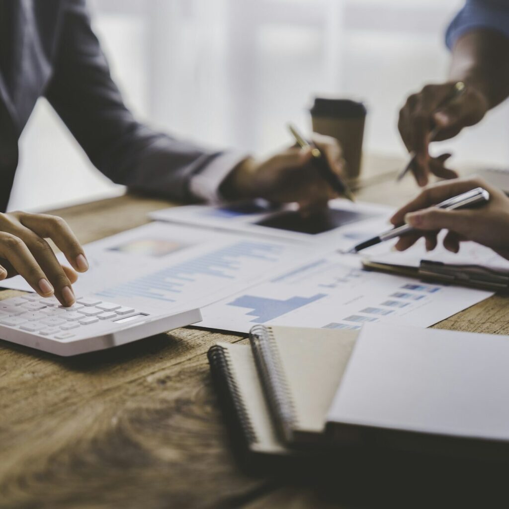 Three professionals reviewing accounting reports in a Kenyan office – Zidika Consulting